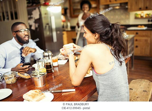 Couple drinking coffee and eating breakfast at table