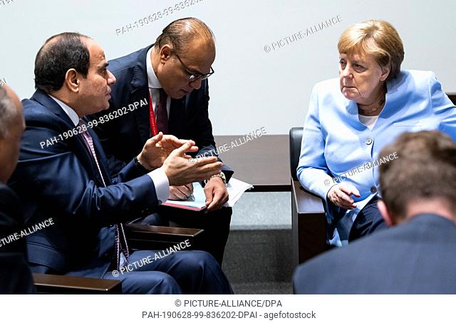 28 June 2019, Japan, Osaka: Federal Chancellor Angela Merkel (r, CDU) and Abdel Fattah al-Sisi (l), President of Egypt, meet in the margins of the G20 summit...