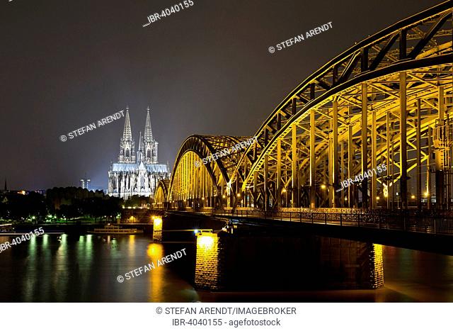 The illuminated Cologne Cathedral and Hohenzollern Bridge at night with Rhine, Deutz, Cologne, North Rhine-Westphalia, Germany