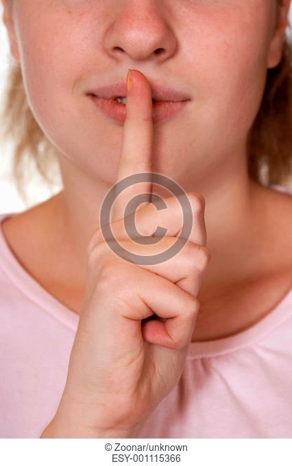 Woman holding finger to lips