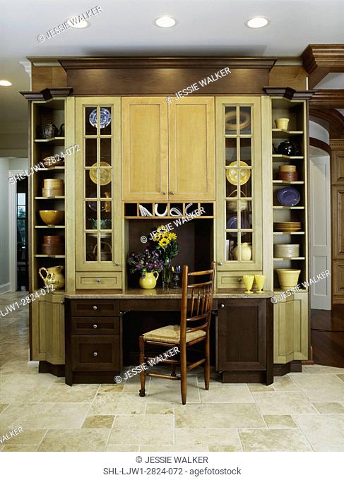 KITCHEN DESK AREAS: stained wood work in three colors, mustard yellow, sage green and brown, glass paned doors, open shelving display, desk chair, tile floor