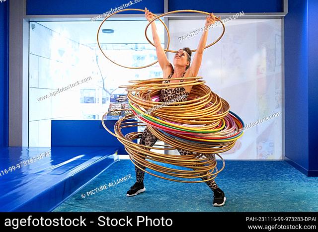 dpatop - 16 November 2023, Saxony, Dresden: Dunja Kuhn moves 84 hula hoops with her body in a world record attempt. Kuhn thus surpasses her previous record from...