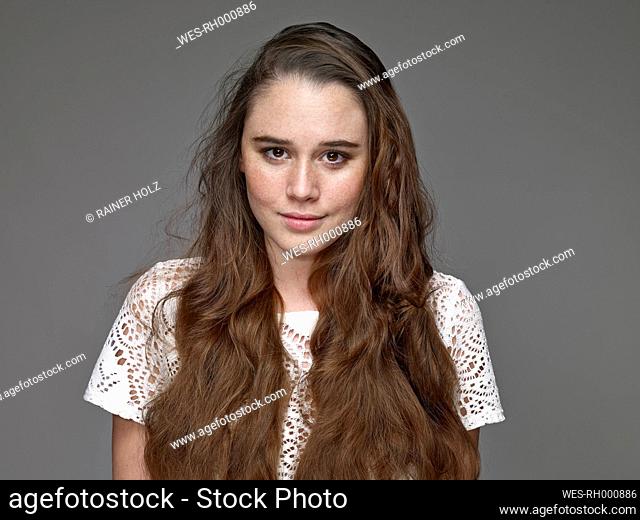 Portrait of smiling young woman with brown hair