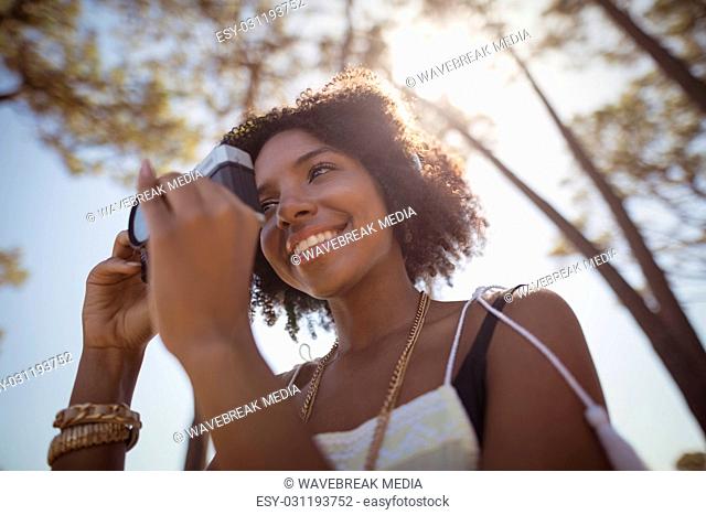 Low angle view of woman photographing