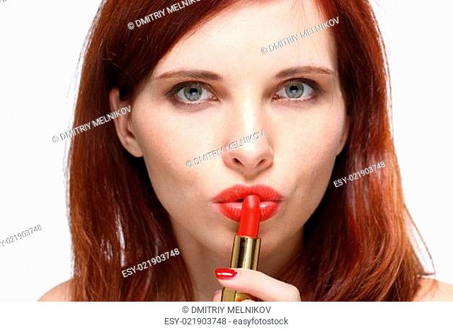 Woman applying lipstick for lips