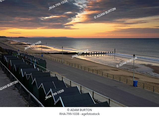 A spectacular sunrise over the beach huts on Bournemouth Beach, Dorset, England, United Kingdom, Europe