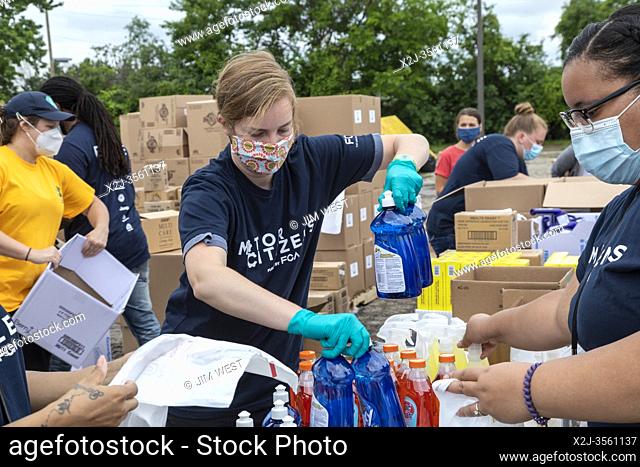 Detroit, Michigan USA - 27 June 2020 - Hundreds waited in line for hours as volunteers from Fiat Chrysler Automobiles distributed food, masks, sanitizer