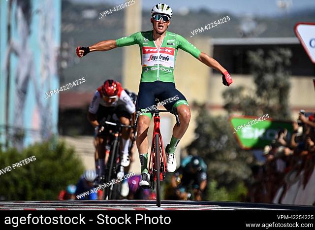 Danish Mads Pedersen of Trek-Segafredo wearing the green points jersey celebrates as he crosses the finish line to win stage 13 of the 2022 edition of the...