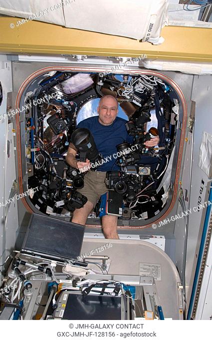 NASA astronaut Don Pettit, Expedition 31 flight engineer, poses with several still cameras in the Cupola of the International Space Station