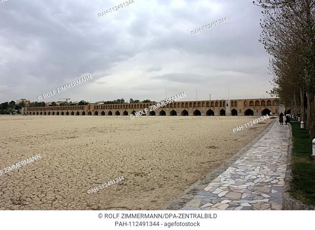 Iran - Isfahan (Esfahan), capital of the province with the Chadschu Bridge in the background. Dry river bed of Zayandeh Rud downstream
