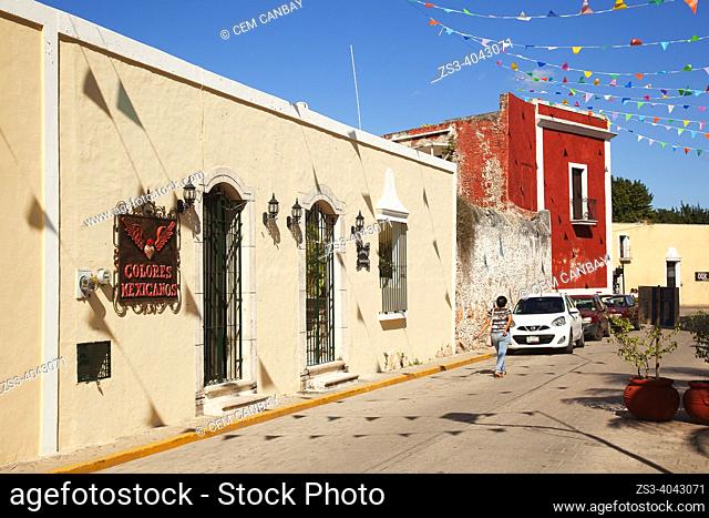 Woman in front of the colonial buildings at Calle De Los Frailes in the historic center, Valladolid, Yucatan Province, Mexico, Central America