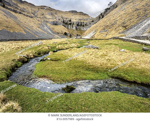 Gordale Beck winding through the valley at Gordale Scar near Malham Yorkshire Dales England