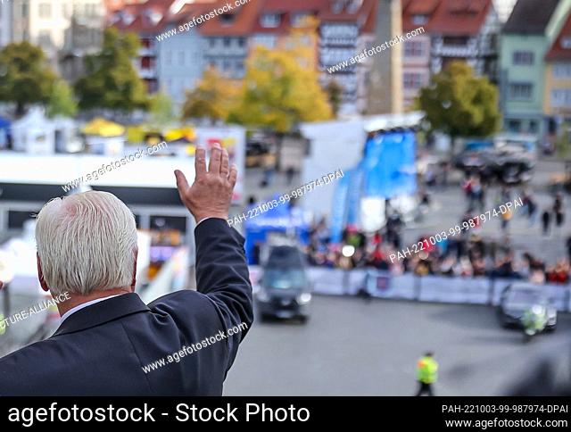 03 October 2022, Thuringia, Erfurt: Frank-Walter Steinmeier, Federal President, waves from the cathedral steps to the few onlookers at the October 3...