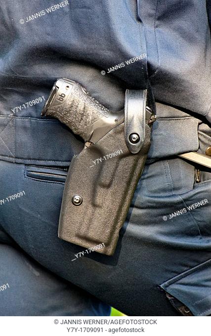 Modern Walther P99 service pistol in a German police officer's hip holster