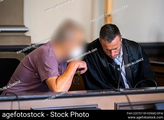 07 July 2022, Lower Saxony, Verden: A man charged with two counts of murder and attempted murder sits in a courtroom at the Verden Regional Court shortly before...