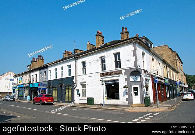 brighouse, west yorkshire, united kingdom - 21 july 2021: shops and bars on bradford road in brighouse west yorkshire