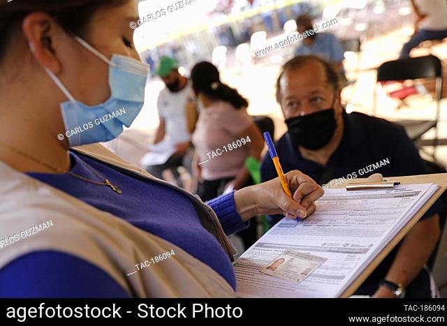 MICHOACAN, MEXICO - MARCH 9: A elderly fill out a form after receive a dose of Pfizer-BioNTech Covid-19 vaccine, during mass vaccine inside of Hermanos Lopez...