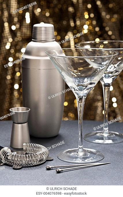 Two Martini glasses with bartender tools