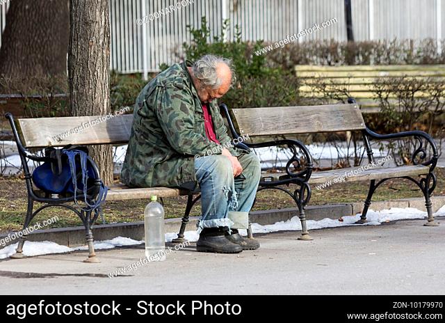 A homeless man is sitting and sleeping on a bench in a park in Bulgaria's capital Sofia. Years after joining the EU the country is still struggling with great...