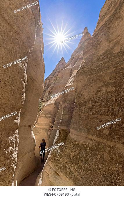 USA, New Mexico, Pajarito Plateau, Sandoval County, Kasha-Katuwe Tent Rocks National Monument, tourist in slot canyon