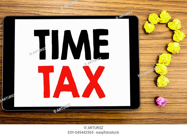 Writing text showing Time Tax. Business concept for Taxation Finance Reminder written on tablet computer on wooden background with question mark made of folded...