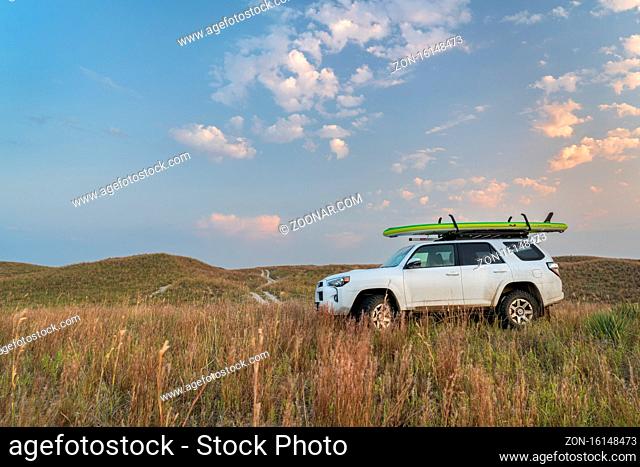 Halsey, NE, USA - September 23, 2020: Toyota 4Runner SUV (2016 trail model) with an inflatable touring stand up paddleboard in Nebraska Sandhills in the Dismal...