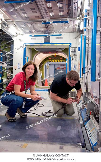 NASA astronauts Doug Wheelock, Expedition 24 flight engineer and Expedition 25 commander; and Shannon Walker, Expedition 2425 flight engineer
