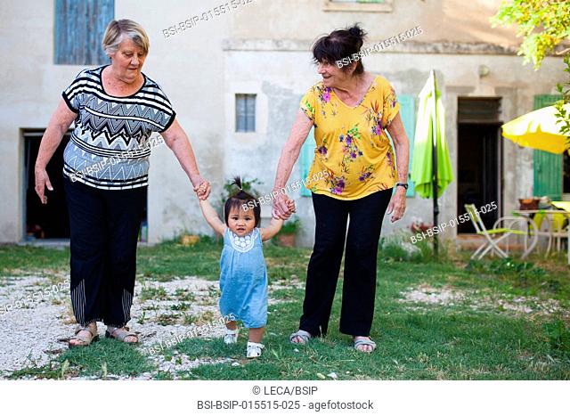 12-month old baby with her adoptive grandmothers