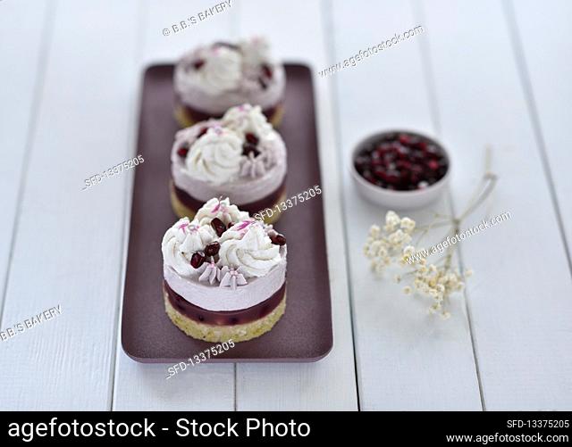 Vegan pomegranate seed cake with orange sponge, fruit jelly and plant-based cream