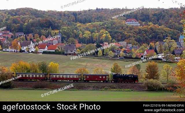16 October 2022, Saxony-Anhalt, Bad Suderode: A train of the Harz narrow-gauge railroad travels through the landscape near Bad Suderode
