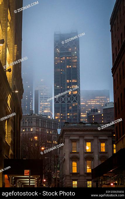 Classic View from the streets downtown Manhattan in New York amid buildings at night