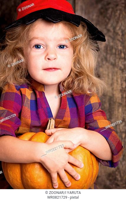 Child with pumpkin