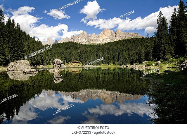 Lake Karersee in the sunlight in front of Dolomites, Nature reserve Schlern Rosengarten, Alto Adige, South Tyrol, Italy, Europe