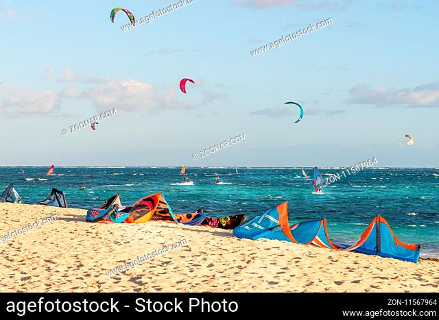 The group of kitesurfing on the beach at Mauritius Island