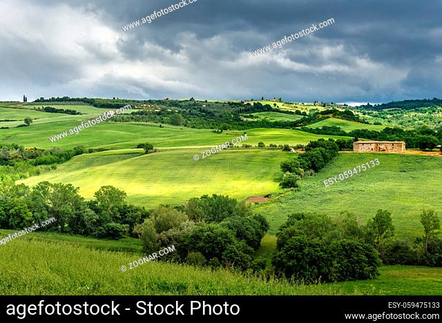 PIENZA, TUSCANY/ITALY - MAY 20 : Verdant rolling landscape and old farmhouse in Tuscany on May 20, 2013
