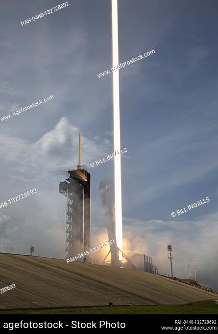 In this photo released by the National Aeronautics and Space Administration (NASA), A SpaceX Falcon 9 rocket carrying the company's Crew Dragon spacecraft is...