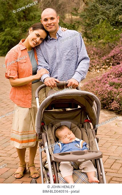 Hispanic parents with baby in stroller