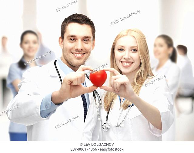 healthcare and medical concept - cardiologists with heart