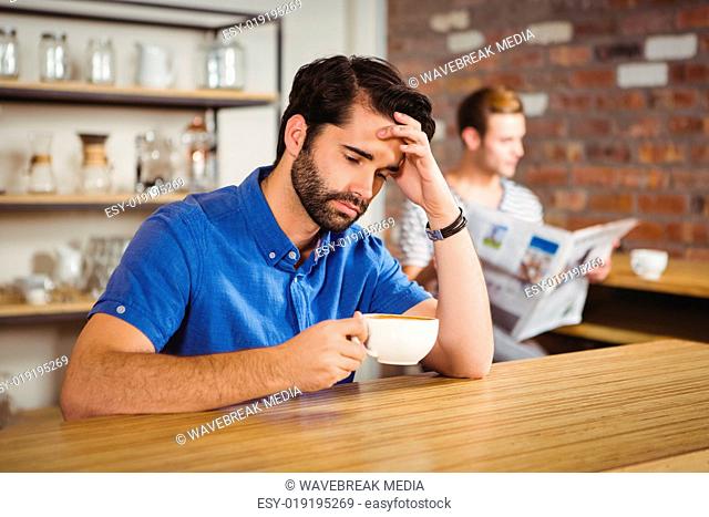 Worried man drinking a coffee