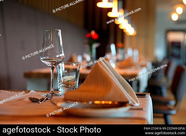 16 April 2021, Saxony-Anhalt, Stolberg: A table set at the Naturressort Schindelbruch. As part of a model experiment, the Ritter von Kempski Privathotels open...