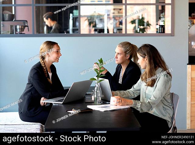 Female coworkers sitting in cafe