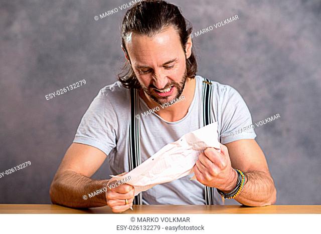 young man is annoyed about a letter