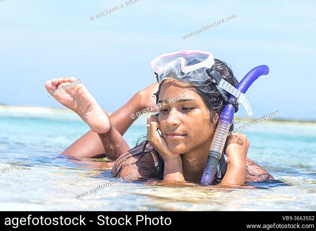 Beach vacation African American Woman snorkeling with mask and barefoot. Bikini woman relaxing on summer tropical getaway sun tanning
