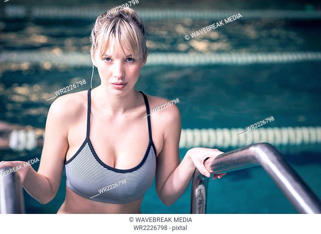 Fit woman about to enter in the pool