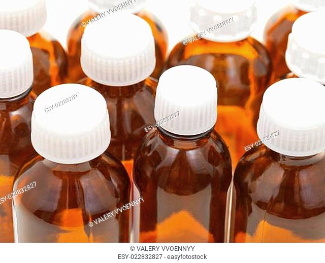 many small closed brown glass pharmacy bottles