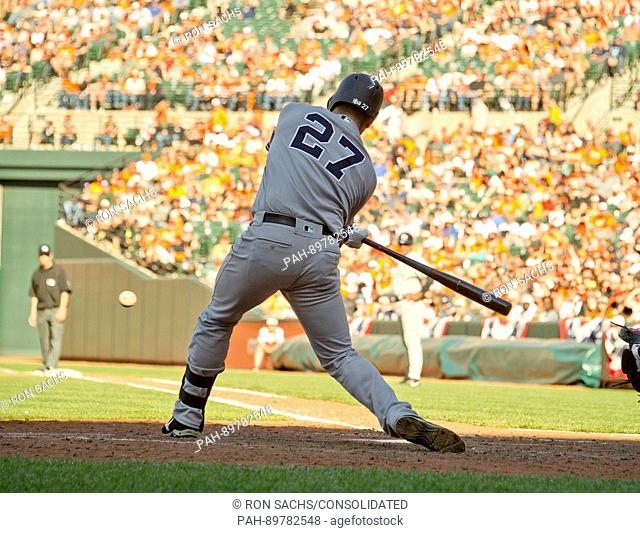 New York Yankees catcher Austin Romine (27) hits a sacrifice fly to center scoring second baseman Starlin Castro (14) and allowing third baseman Chase Headley...