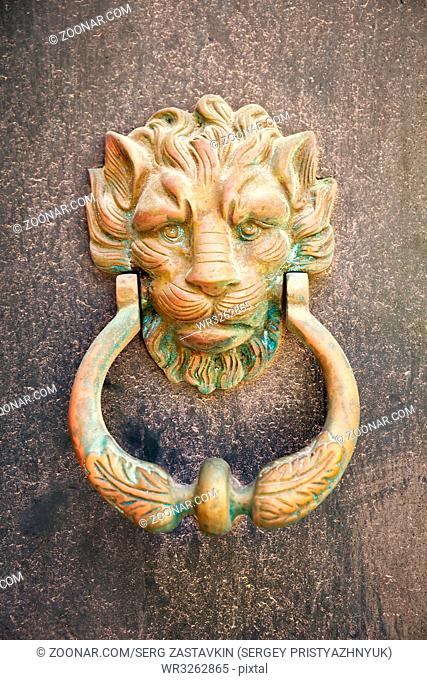 An old style decorative bronze door handles in form of lion head, the distinctive feature of Malta in Mdina