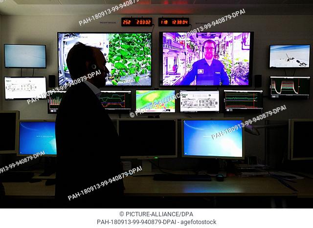 13 September 2018, Bremen: Daniel Schubert (l), EDEN ISS project manager, stands in a surveillance room at DLR (German Aerospace Center) and talks to space...