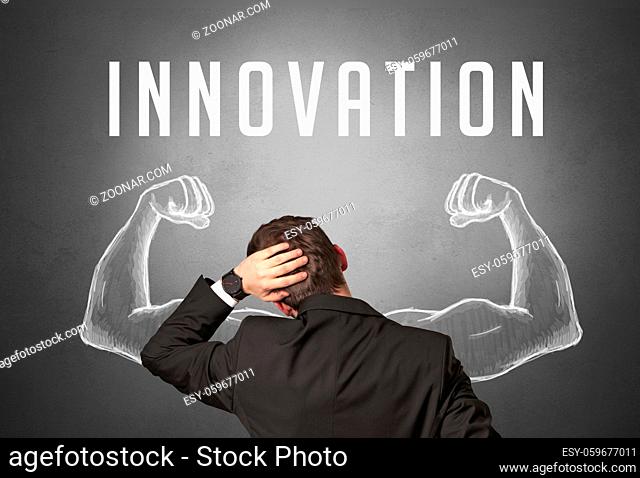 Rear view of a businessman with INNOVATION inscription, powerfull business concept