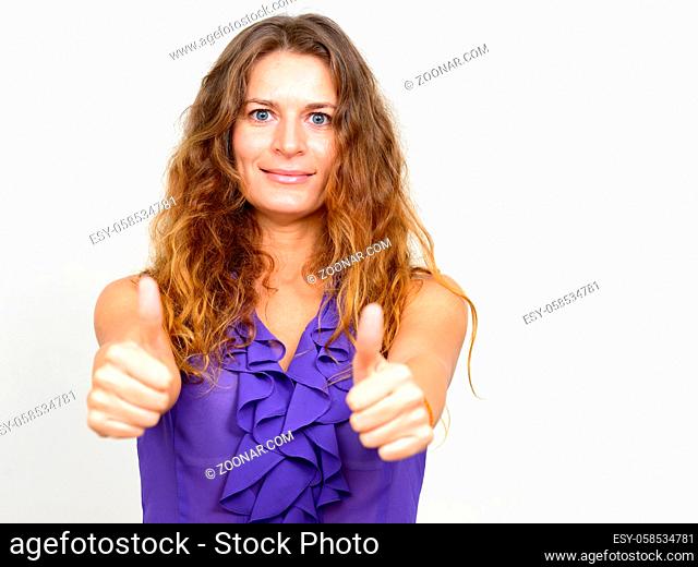 Studio shot of young beautiful businesswoman with curly blond hair against white background